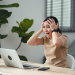 Asian woman sitting at home office thinking about Shopify mistakes