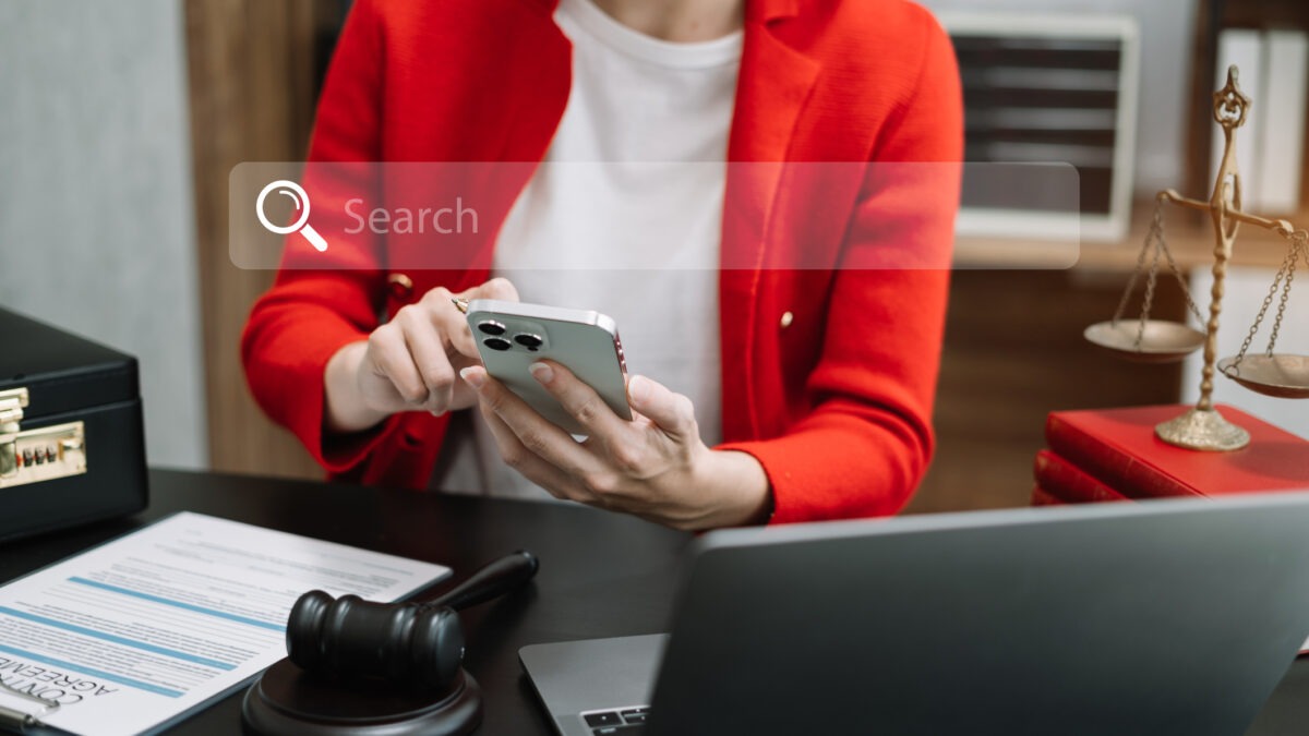 A lawyer sitting in her office, working on local SEO for lawyers using a laptop to get more legal clients