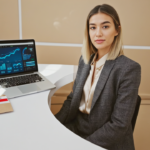 A UK small business owner working on a laptop displaying Shopify advanced analytics and payment options, illustrating advanced Shopify features for UK stores in a professional office setting.